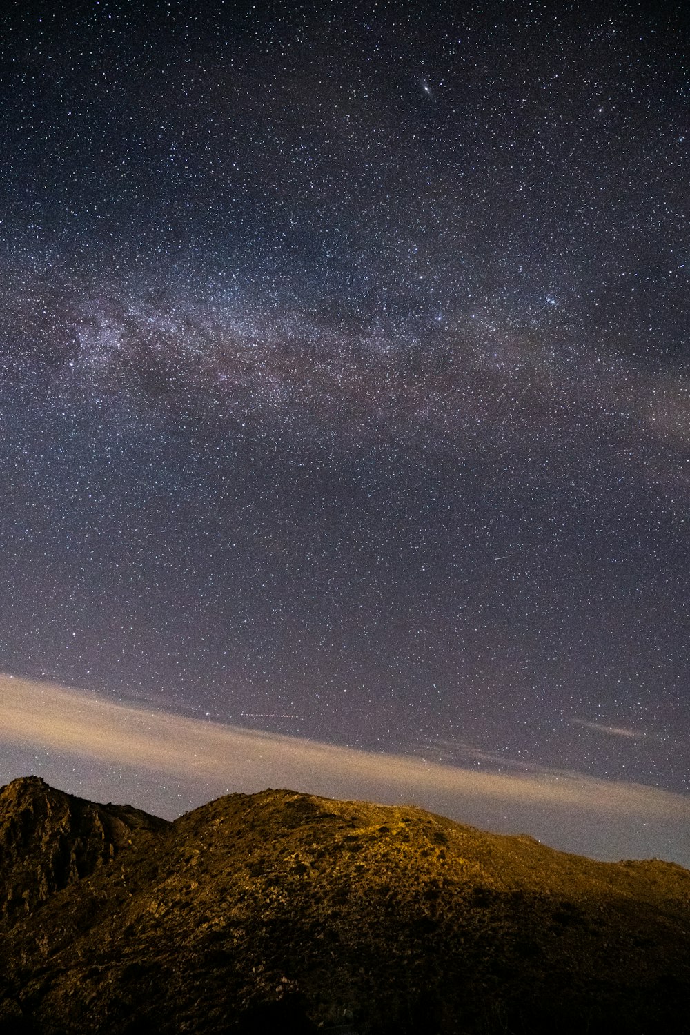 starry skies above mountain ranges