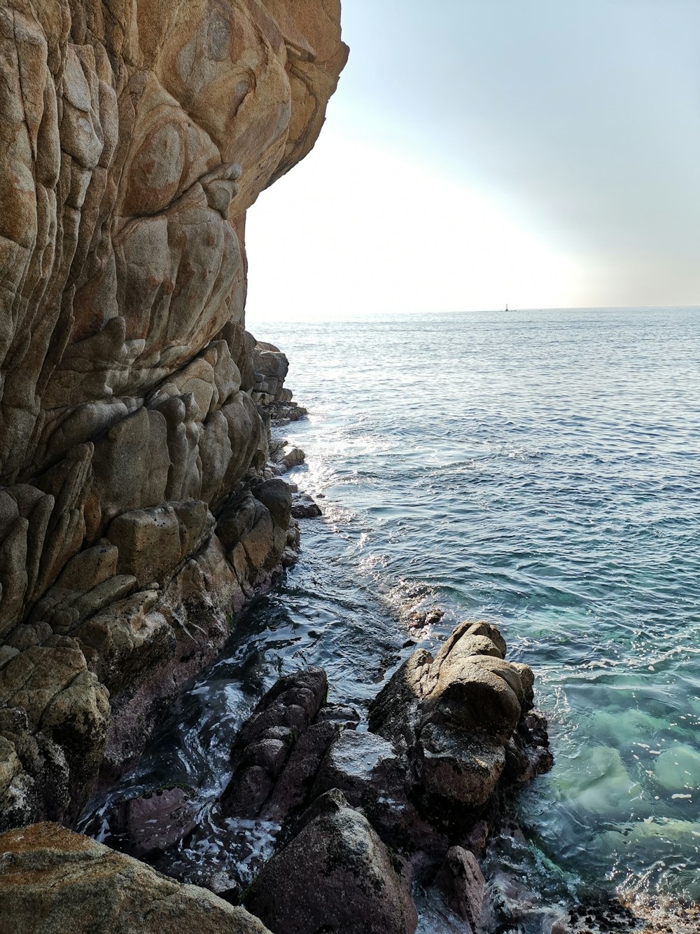rock formation beside body of water
