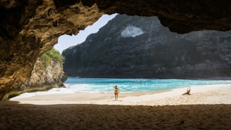 landscape photography of woman standing on seashore