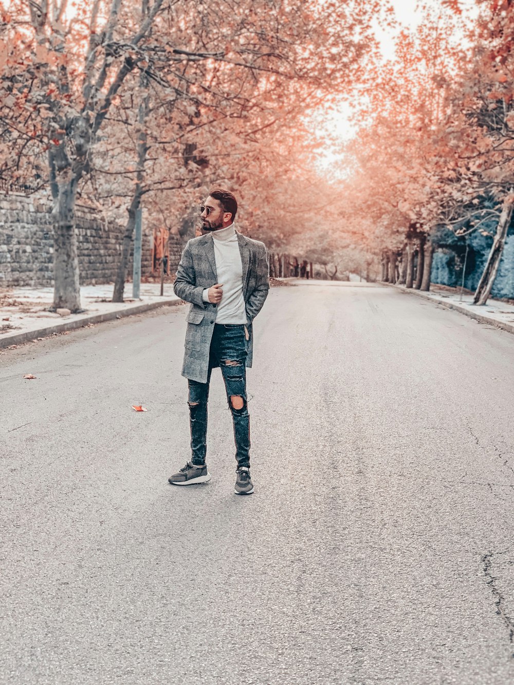 man standing on road