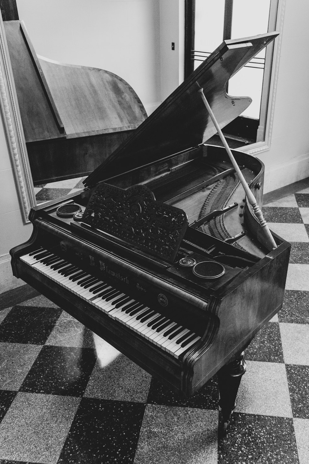 greyscale photo of grand piano