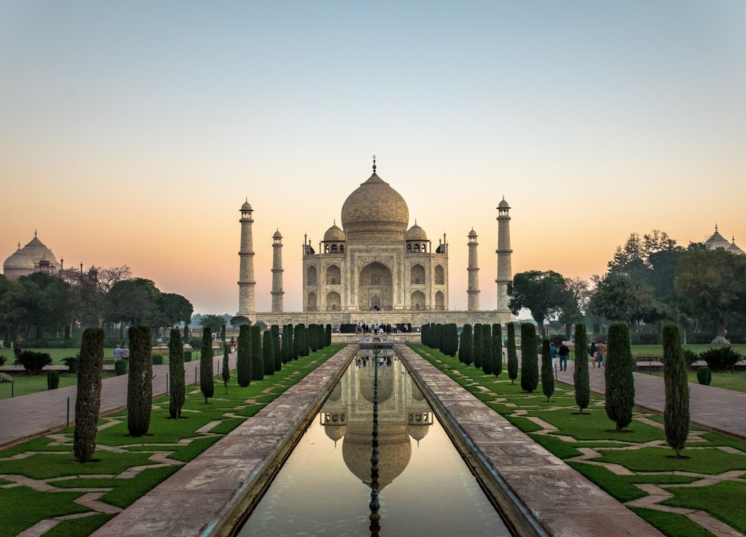 reflections of white mosque on water, Sunrise at Taj Mahal