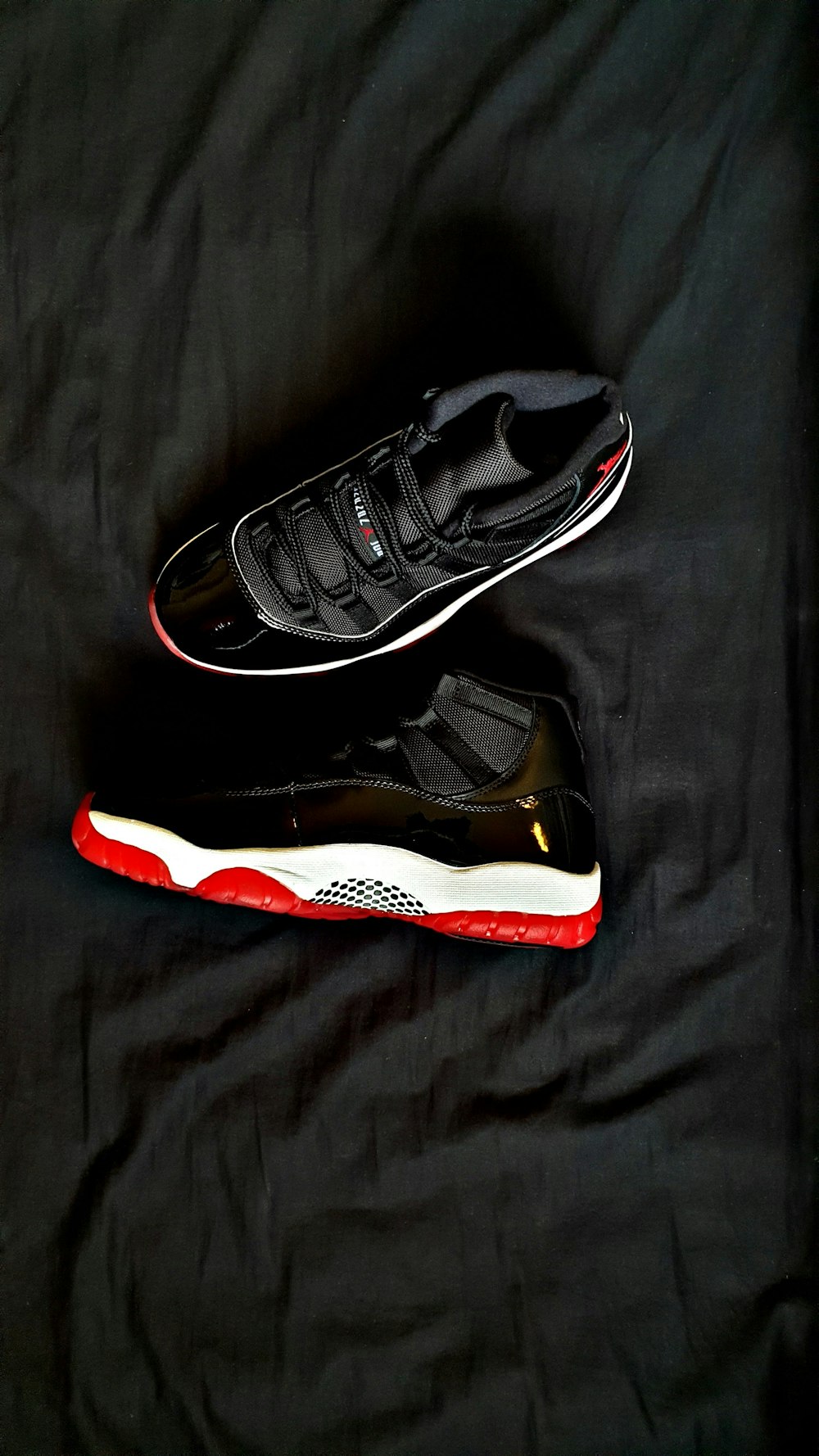 pair of black Air Jordan 11's