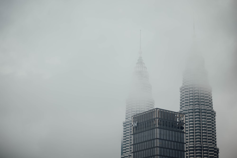 a very tall building in the middle of a foggy day