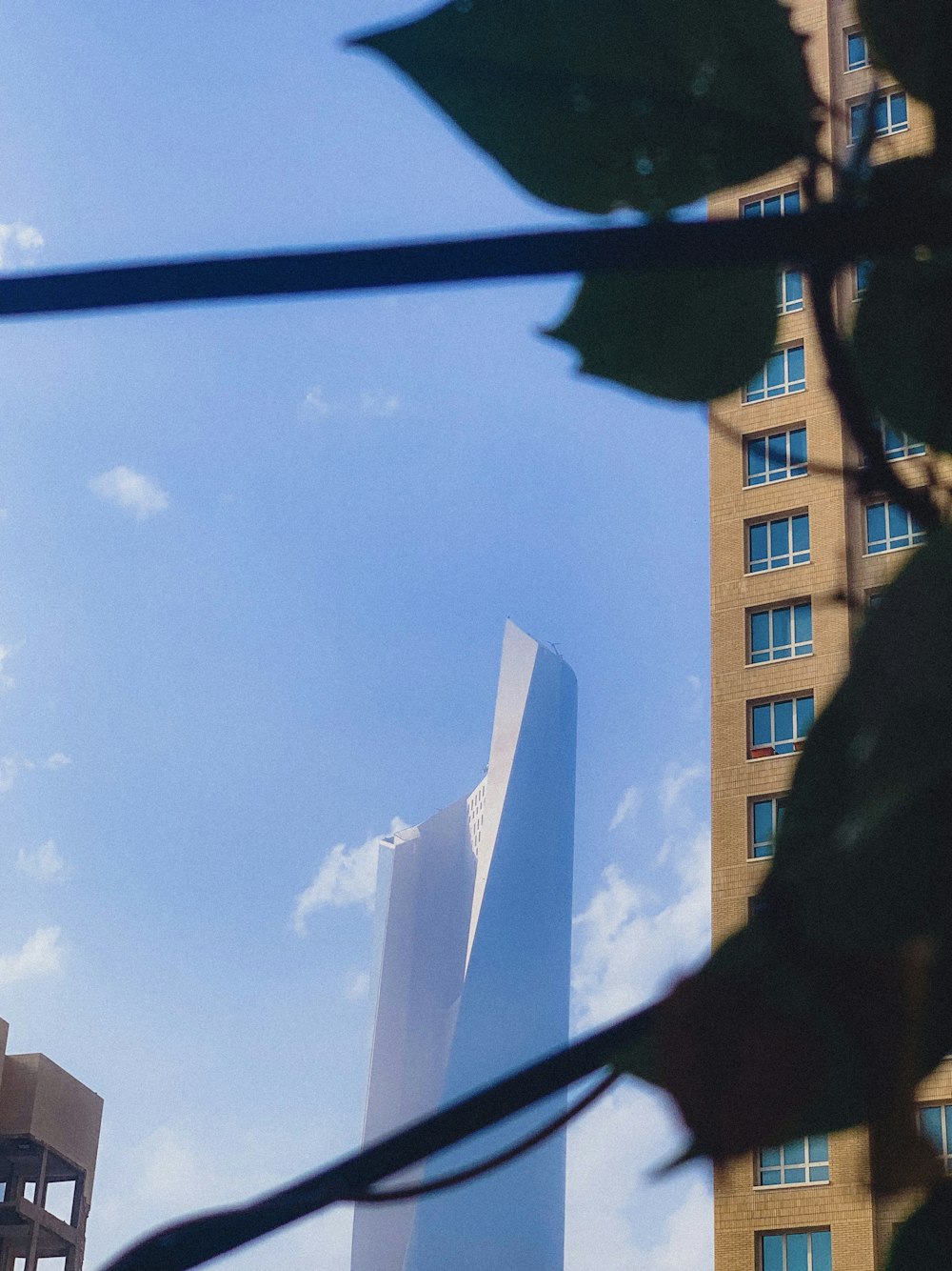 white high-rise building under a calm blue sky