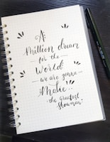 An open journal displaying handwritten inspirational quotes.