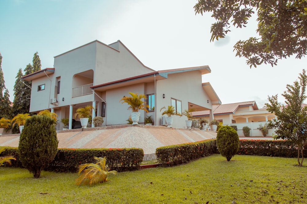 white painted house with green grass garden