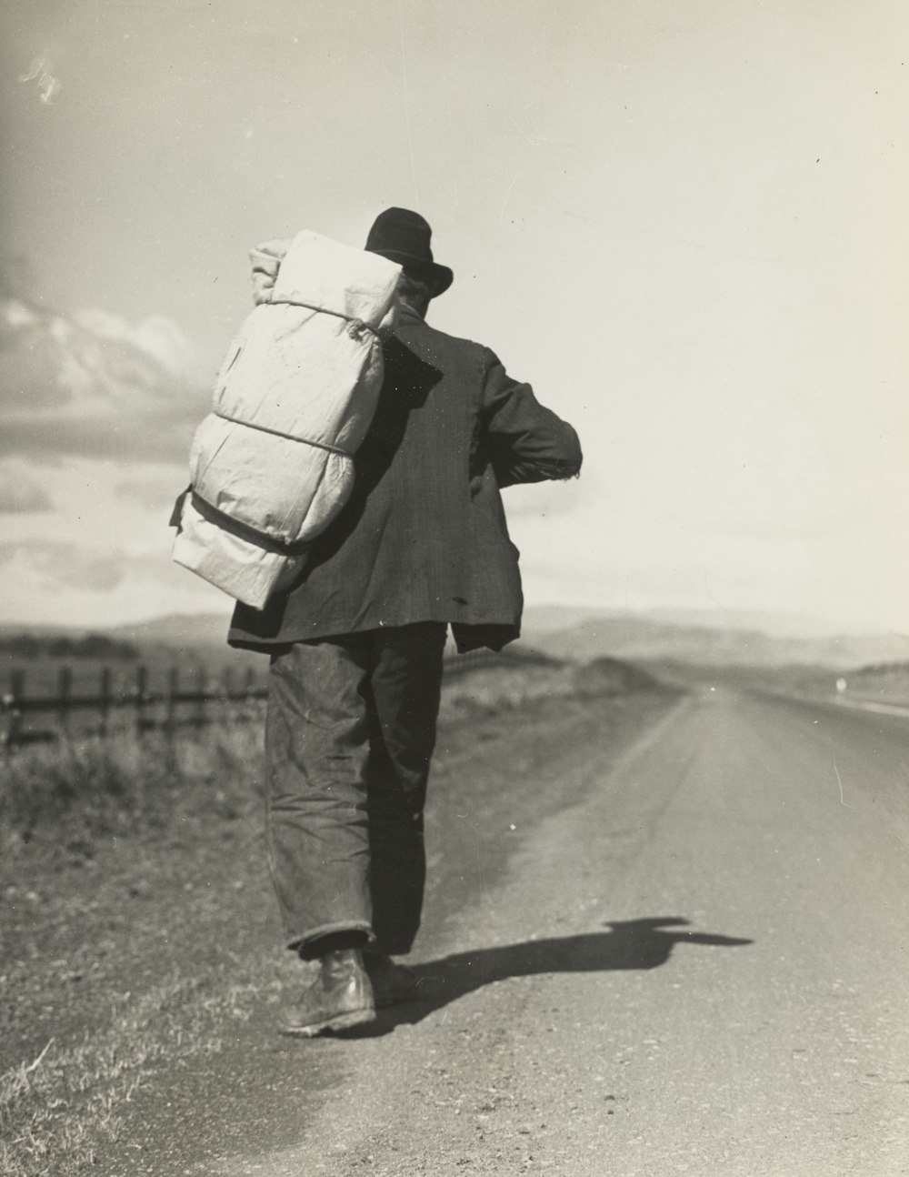 man walking beside road