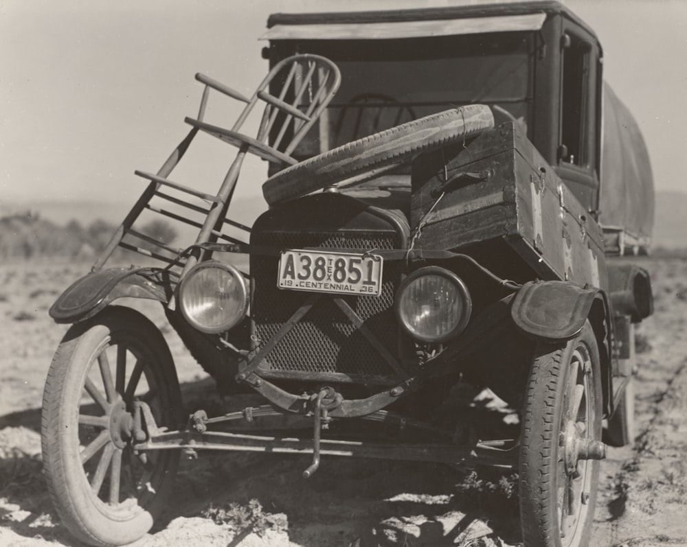 grayscale photography of vintage vehicle on road