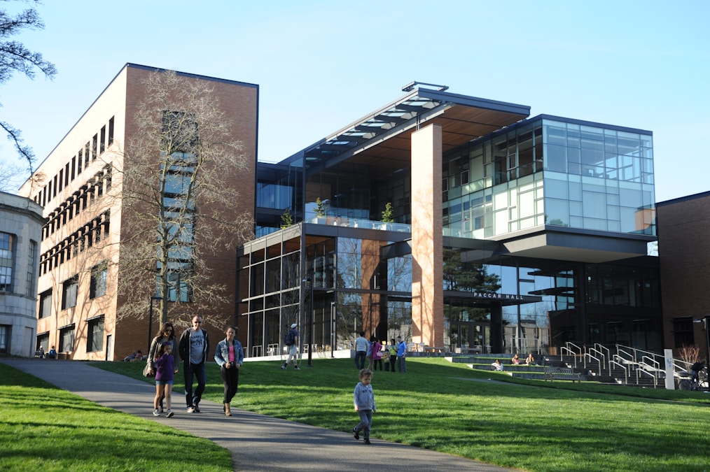Students walking near a university building on a sunny day
