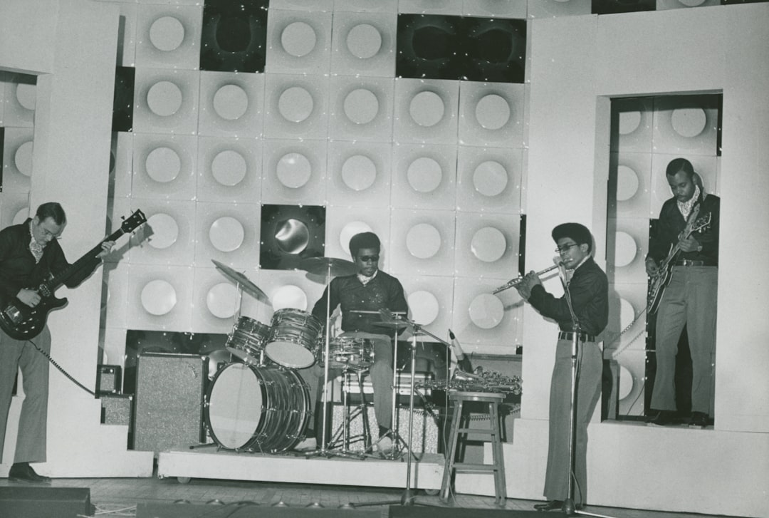 grayscale picture of four male performing band