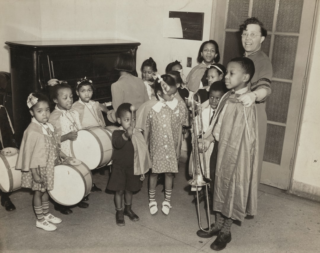 grayscale picture of a woman and group of children