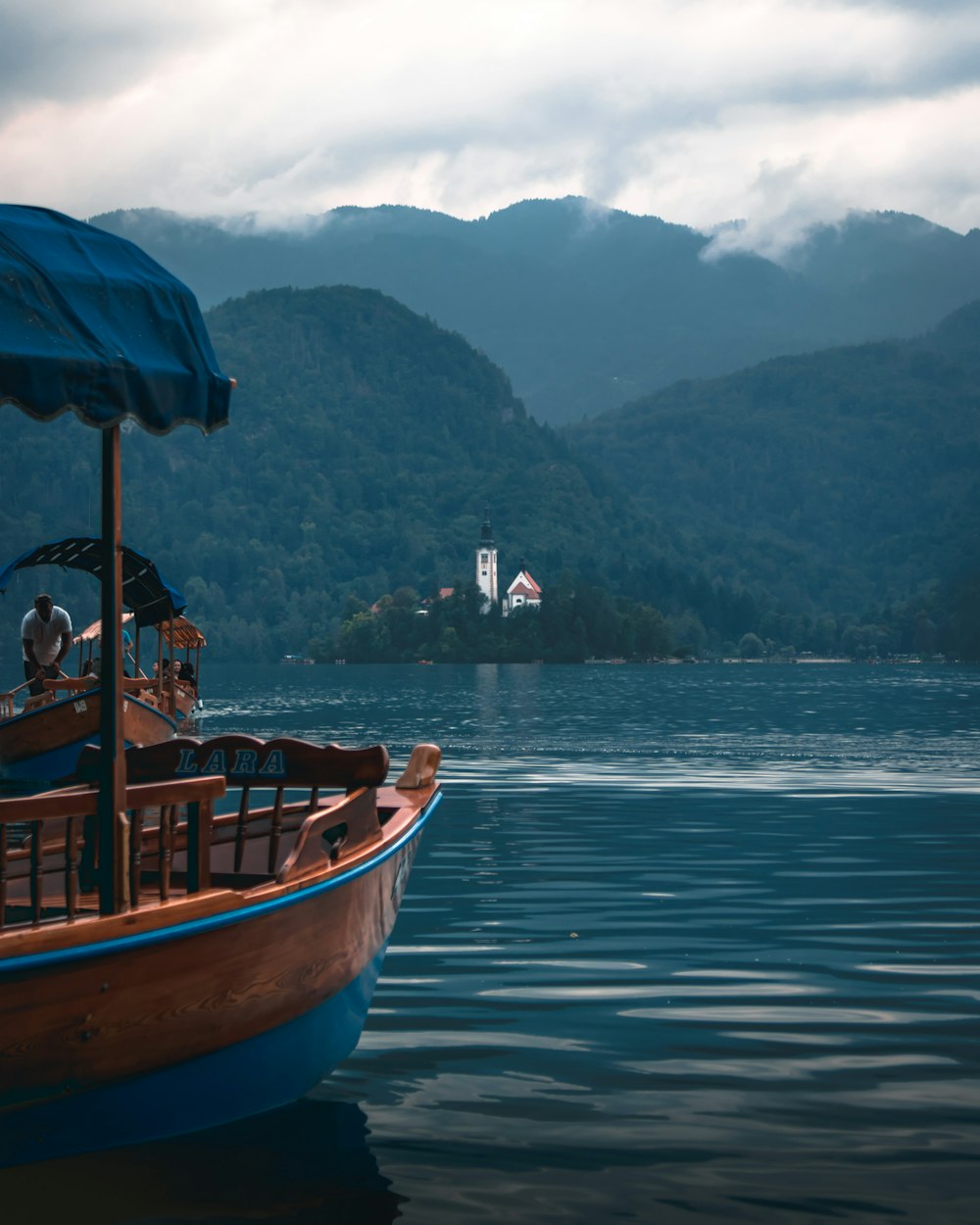 brown and blue wooden boat floating in water