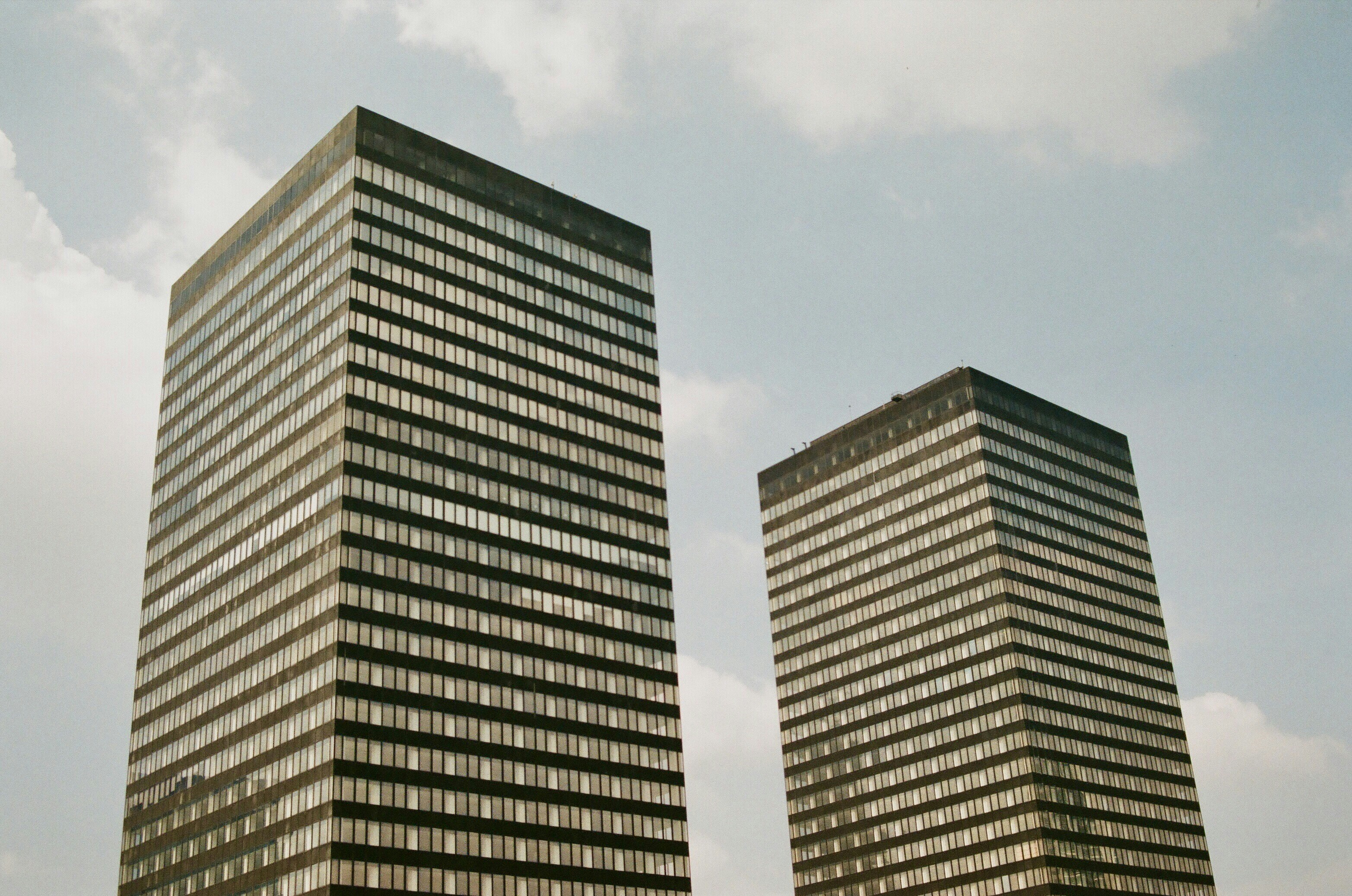 two high-rise buildings under gray sky