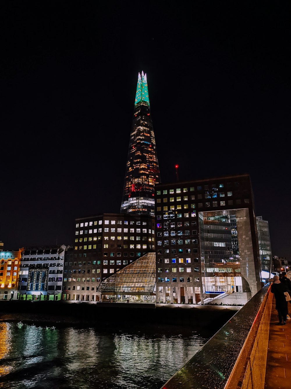 a view of a city at night from a bridge