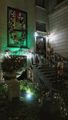 Guests happily arriving at a welcoming home decorated for the holidays.