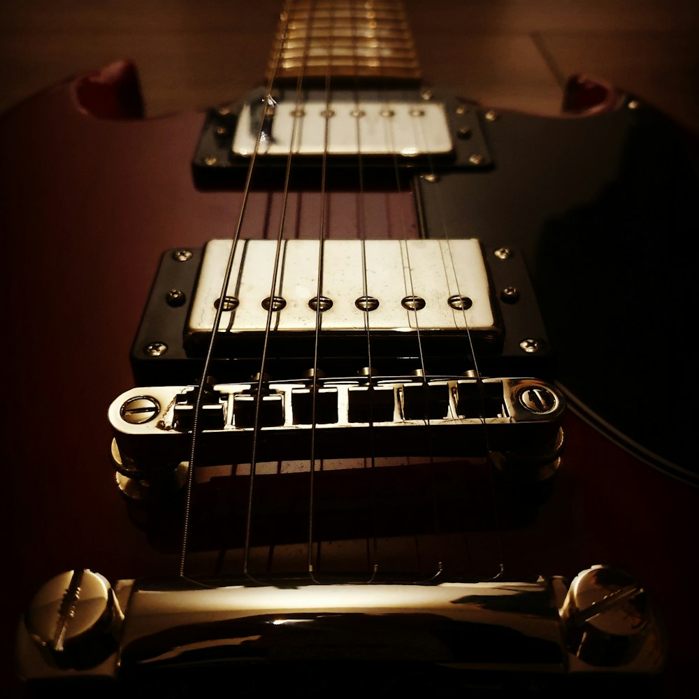 macro photography of brown electric guitar