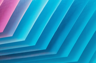 a bunch of blue and pink papers stacked on top of each other