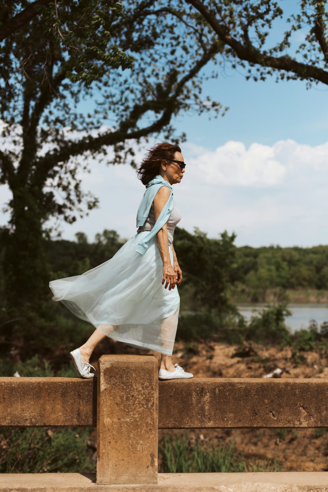 elderly woman walking on fence