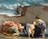 A woman is seated on the ground, cradling a child in her lap. The child is unclothed, and the woman is dressed in a flowing gown. An older man is sleeping on the ground nearby, wrapped in a robe. A donkey peers over a brick wall in the background, and the sky is cloudy yet bright.