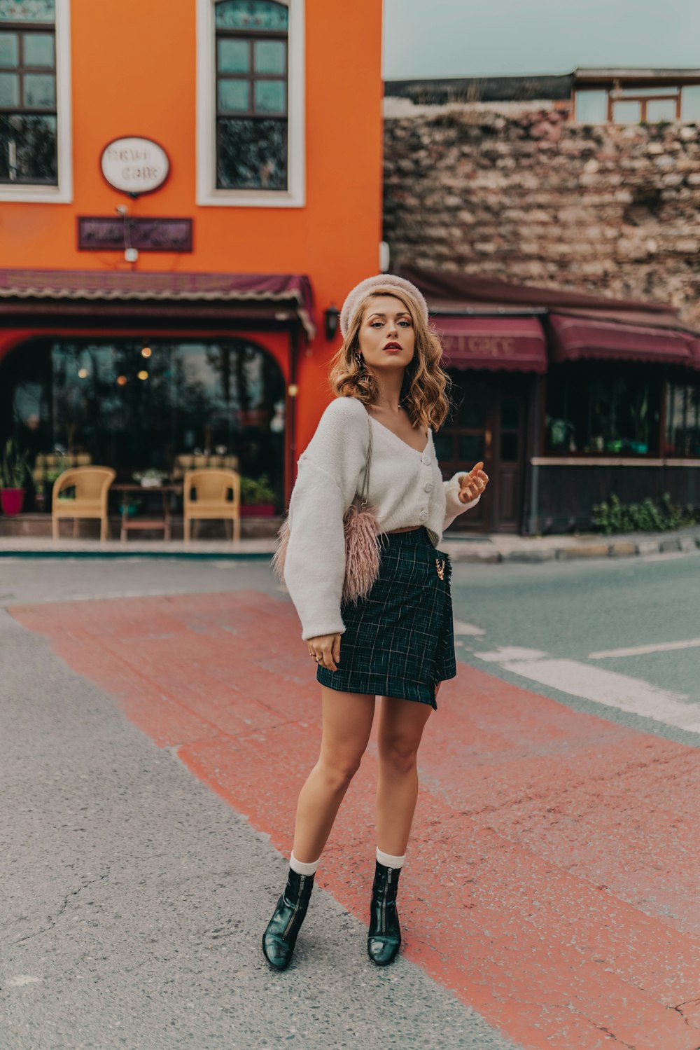 woman in white V-neck sweater and black mini skirt