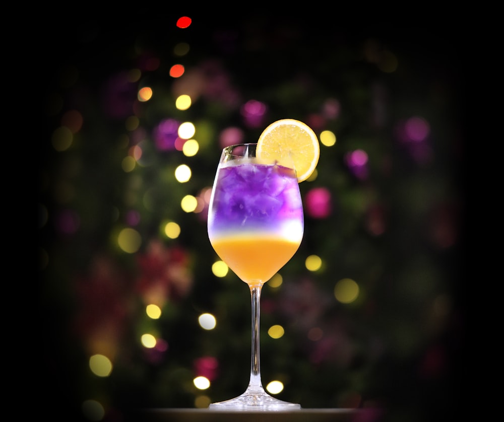 yellow and purple drink in wine glass