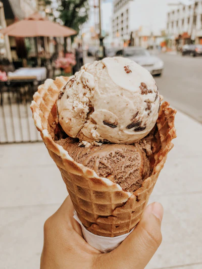 Fresh waffle cone being pressed and rolled by hand
