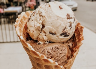 person holding ice cream in cone