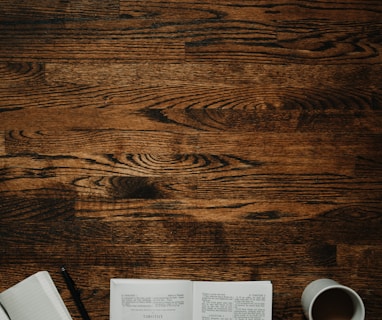 person sitting by the table opening book