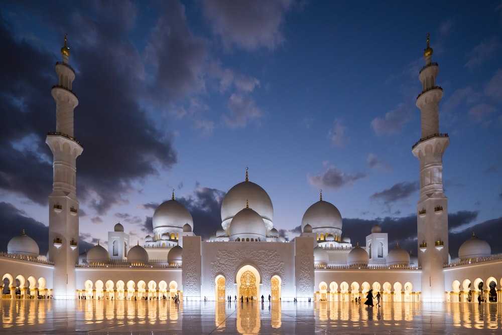 white mosque under cloudy sky