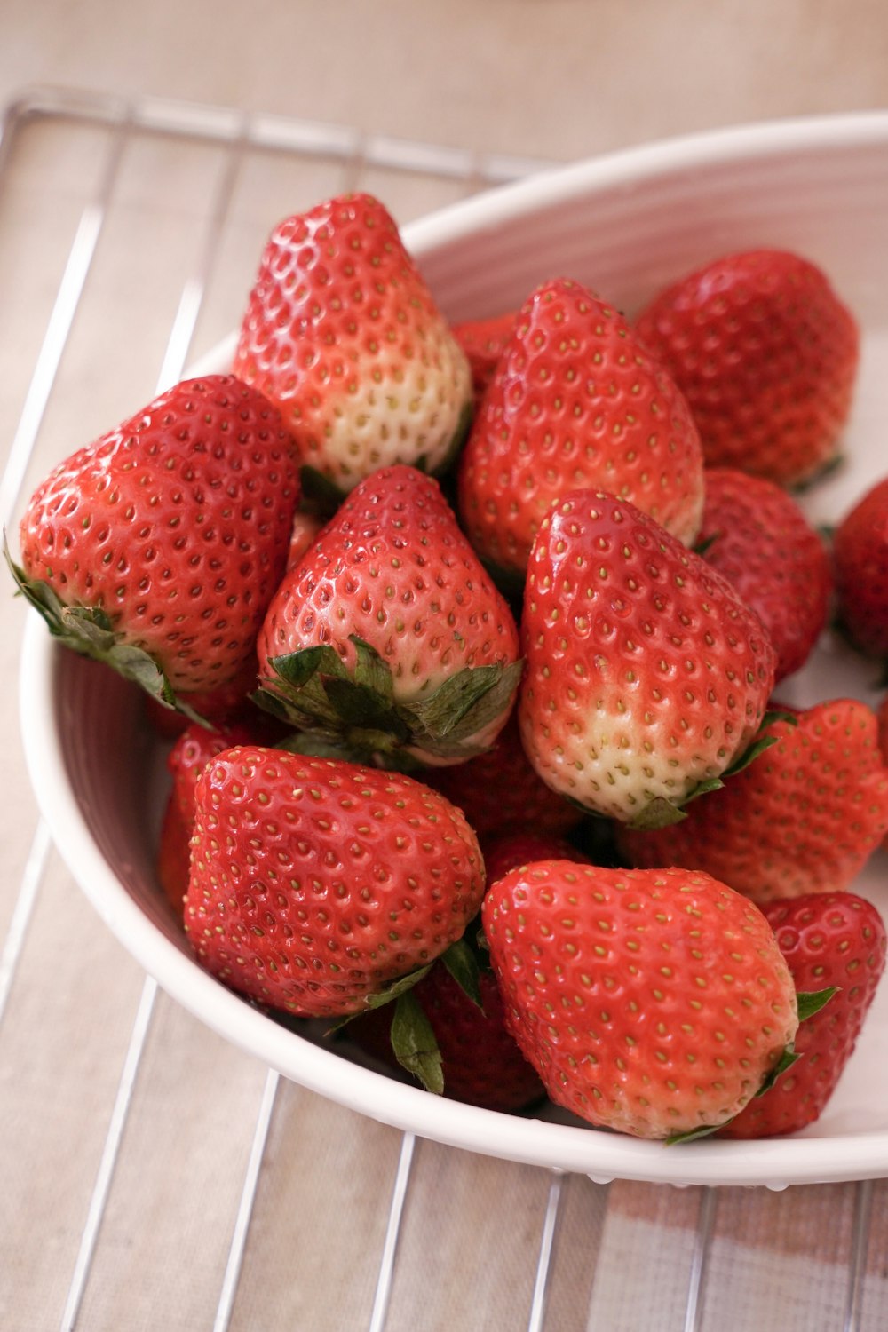 shallow focus photo of red strawberries in white ceramic