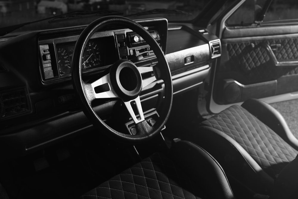 grayscale photo of car dashboard