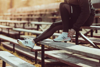 injured runner sitting on bleachers