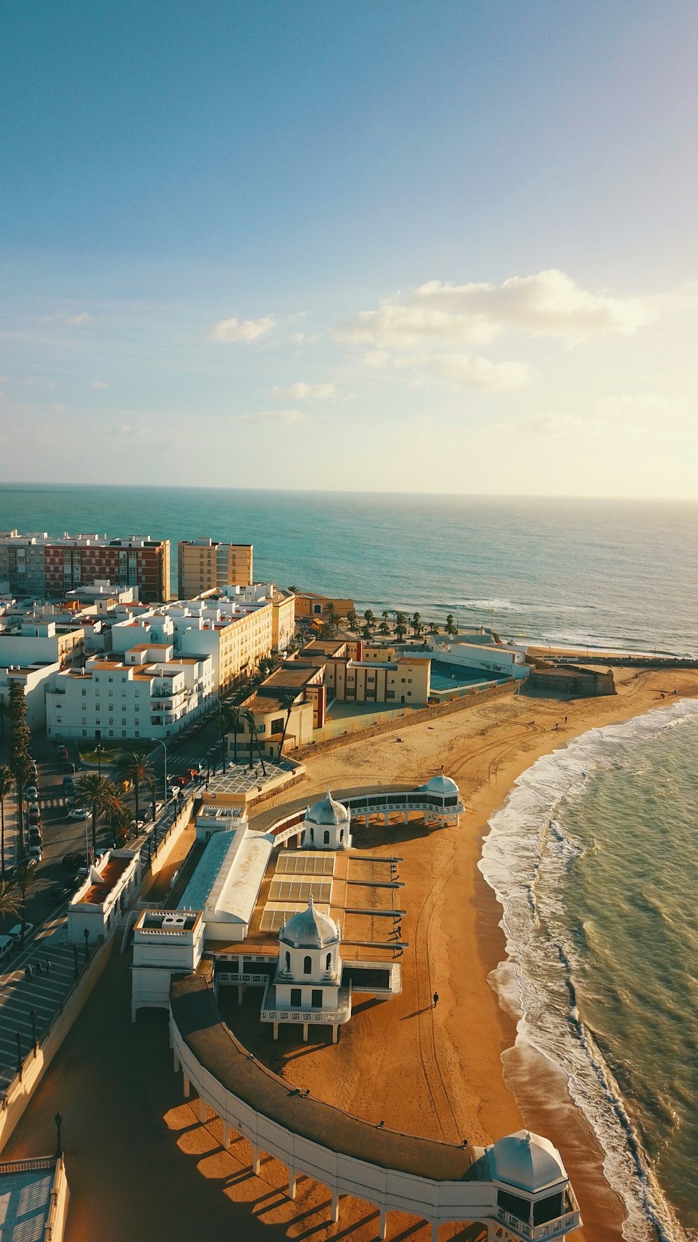 wide-angle photography of buildings beside seashore during daytime