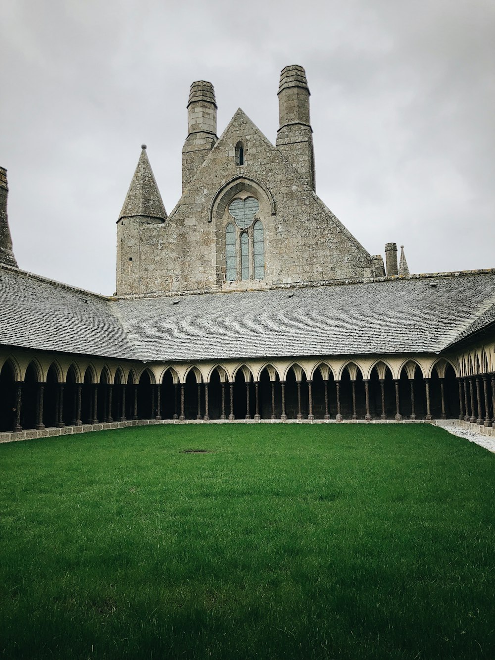 a large building with a green lawn in front of it