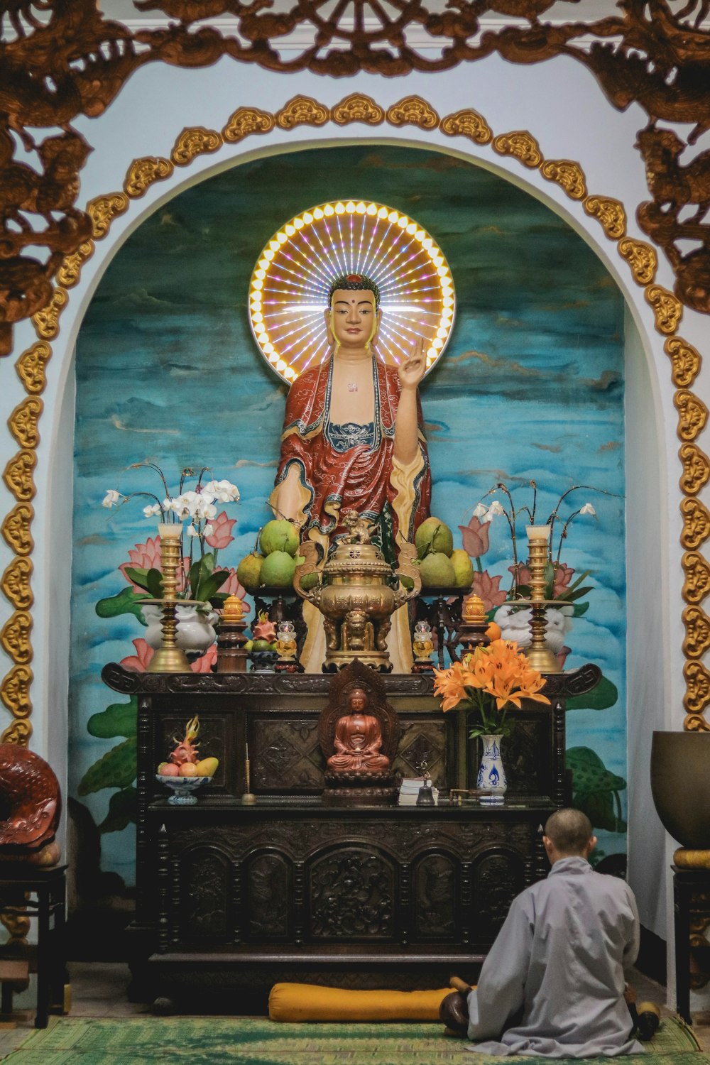 man sitting in front of an altar