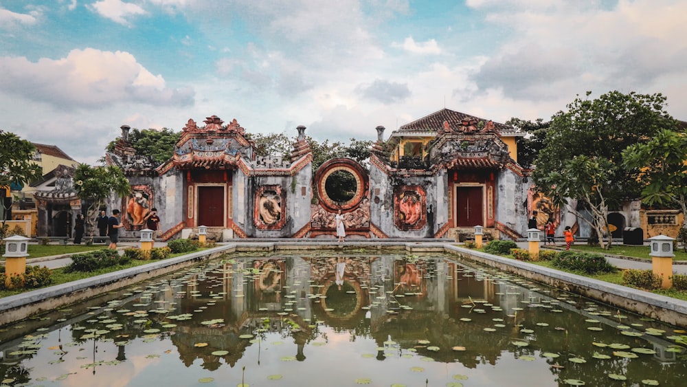 reflection of building on pond during daytime