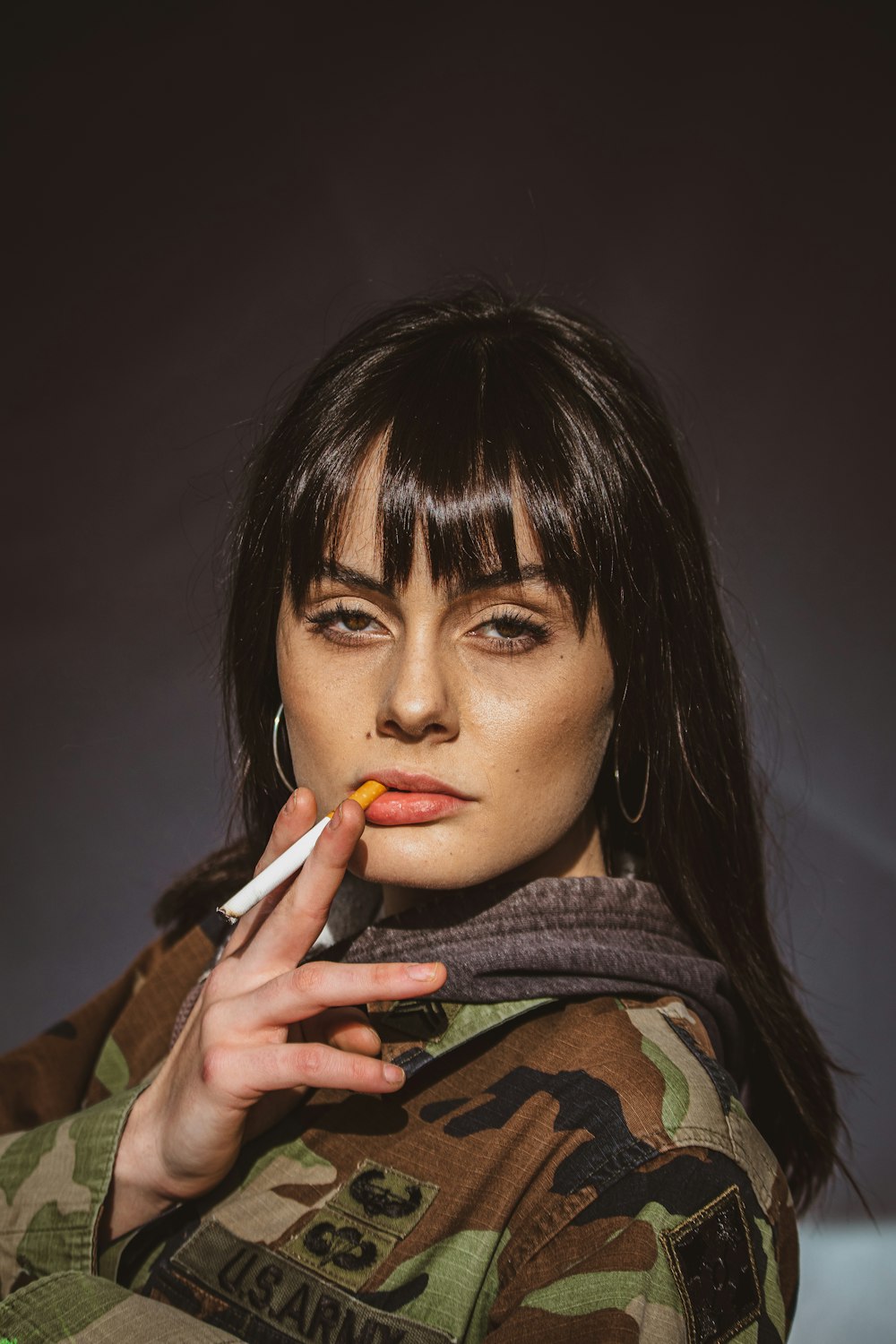 woman holding unlit cigarette stick