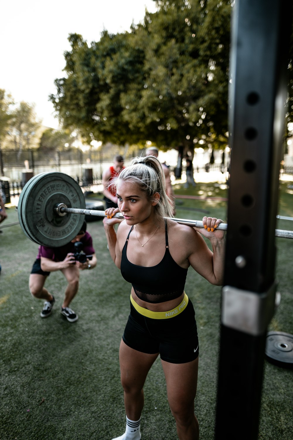 woman lifting a barbell on her back