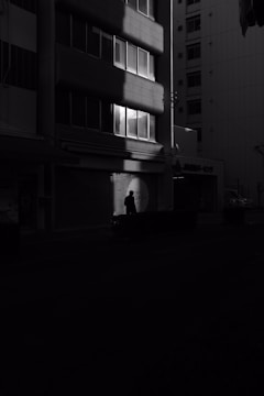 A striking frame from a moody urban night film with sharp lighting contrasts.