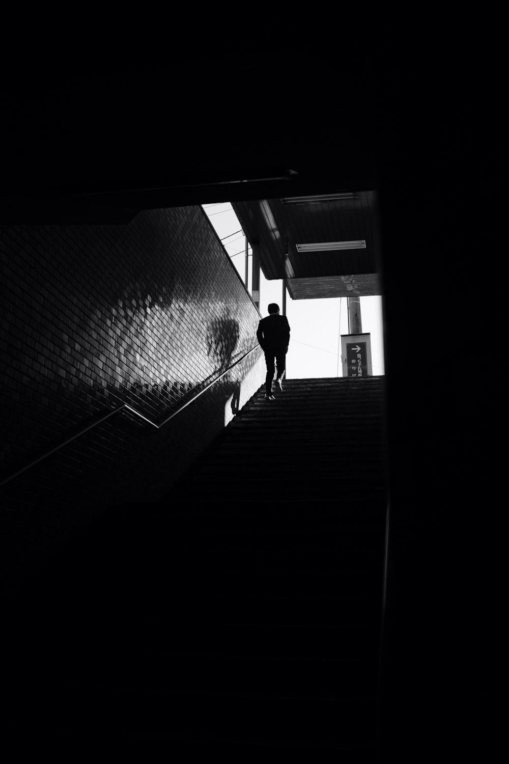 silhouette of person walking on stairway