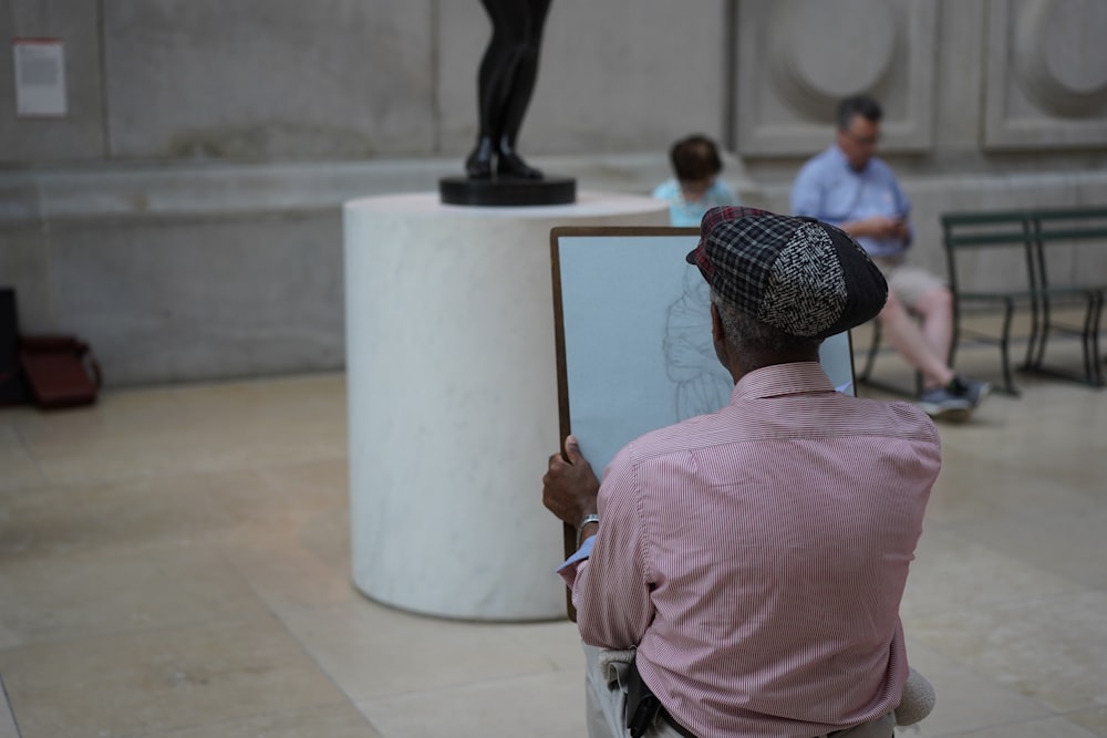 man painting statue