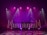 A dimly lit stage features vibrant purple and pink lighting emanating from spotlights and LED bars. The backdrop displays abstract patterns, while the floor reflects circular and linear light patterns, creating an energetic and dynamic visual atmosphere.