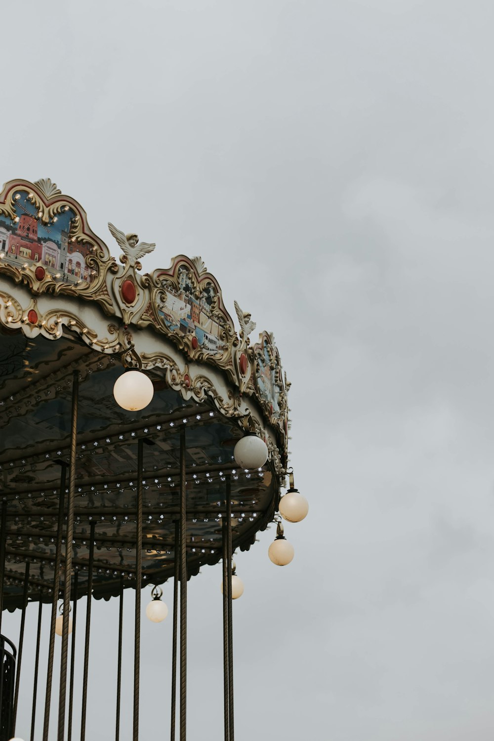 a close up of a merry go round on a cloudy day
