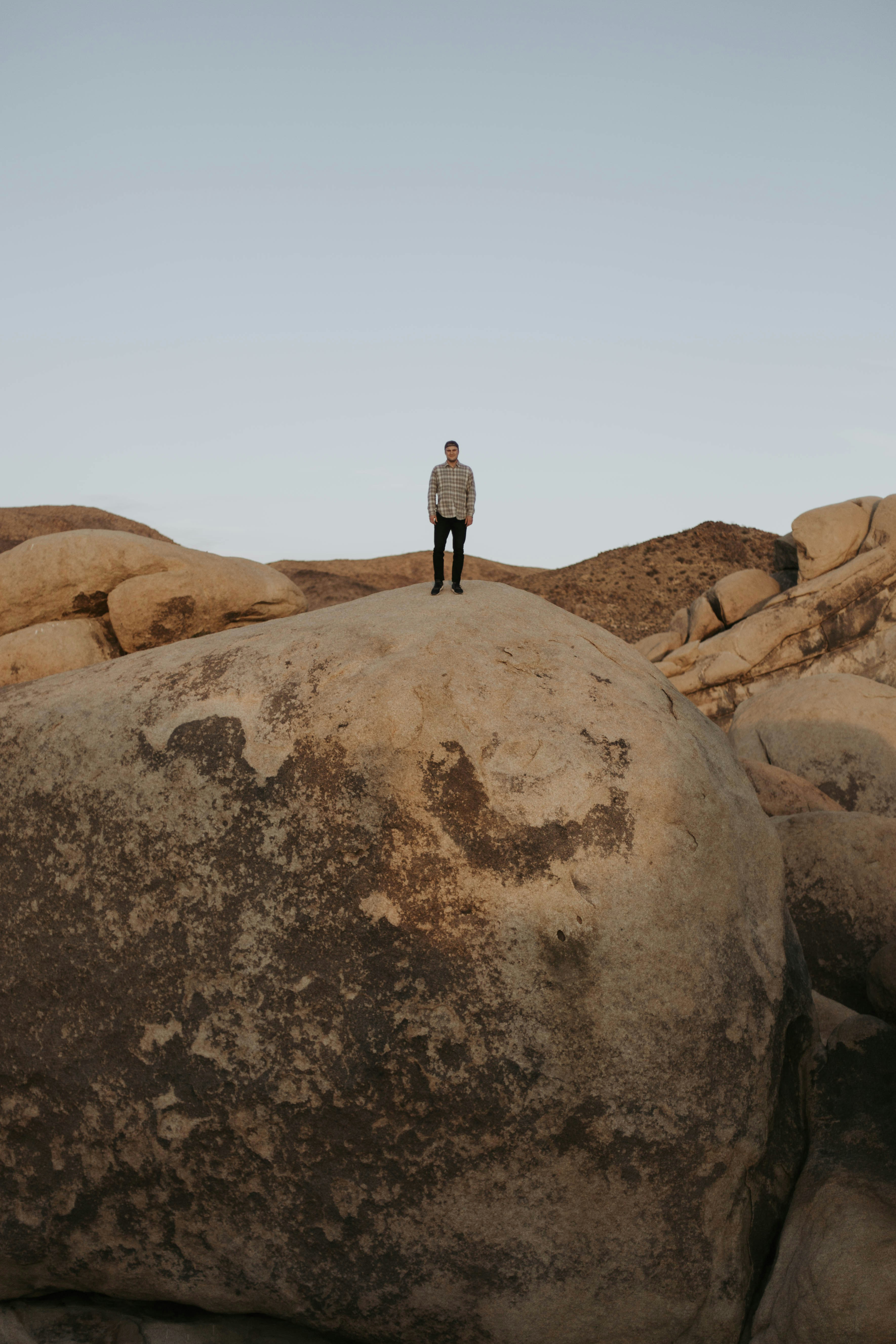 man standing on cliff during daytime