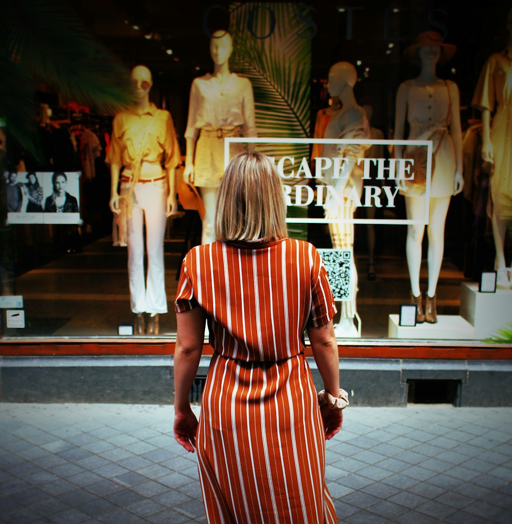 woman in front of clothes store