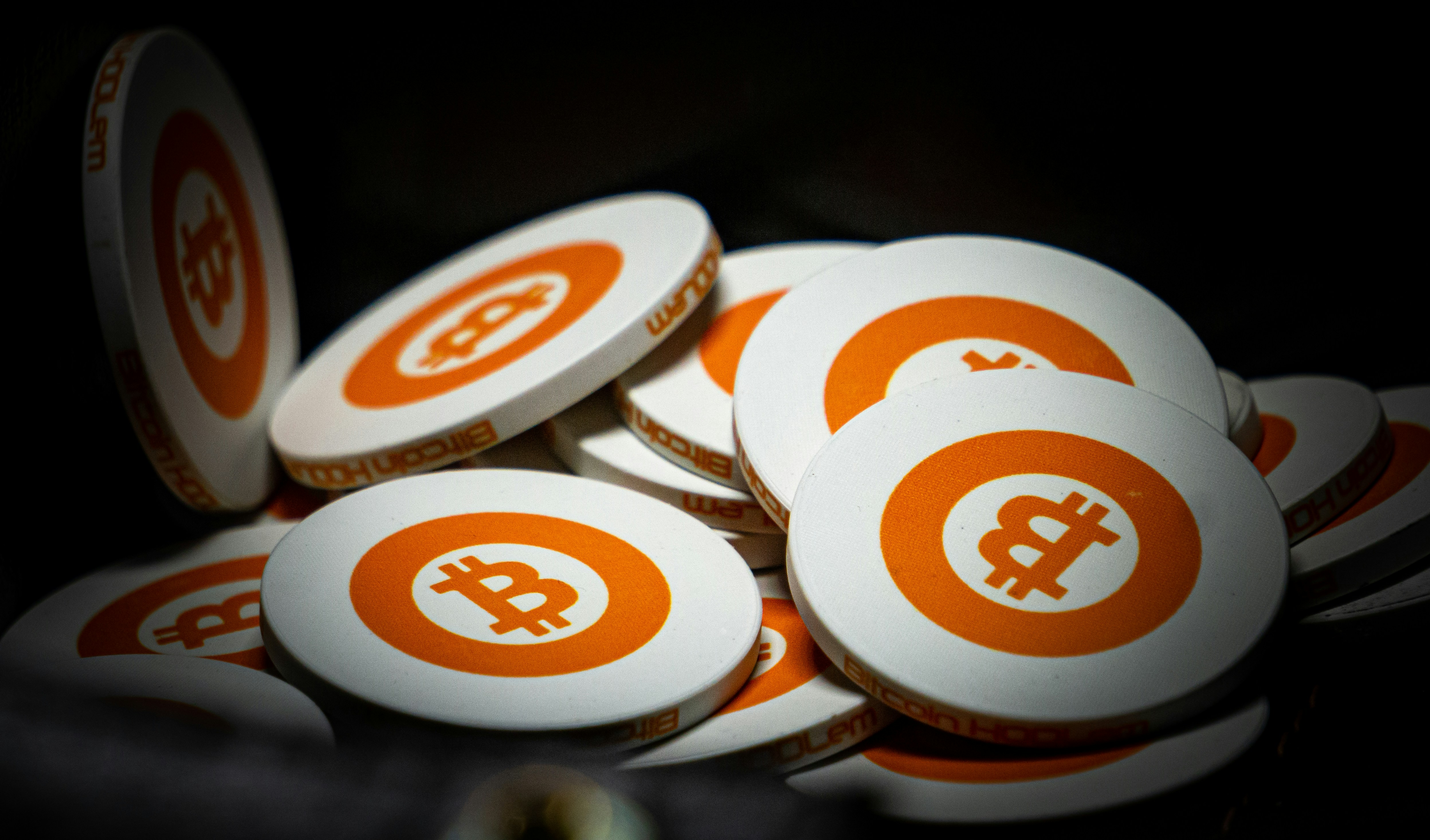 Bitcoin style poker chips with the Bitcoin currency symbol on them.