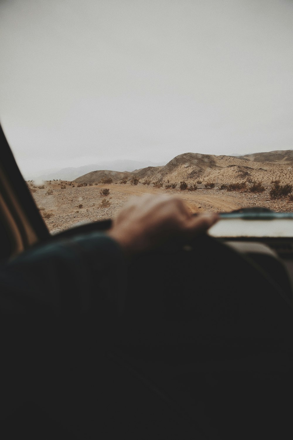 a person driving a car in the desert