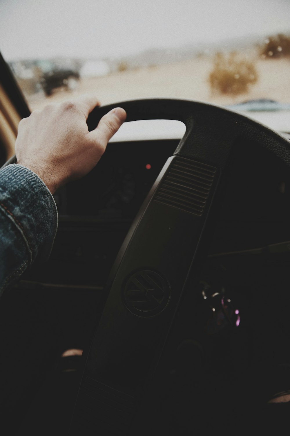 person holding Volkswagen steering wheel