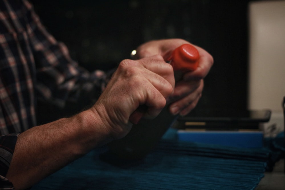 a man holding a red object in his hand